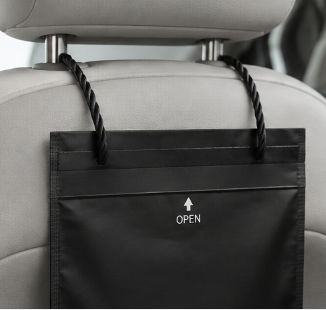 CleanaCabs bag hanging from car headrest – empty